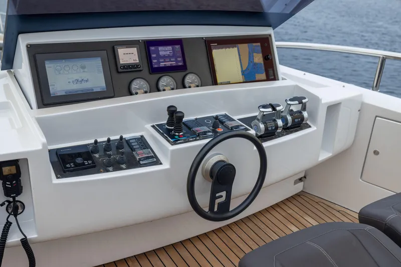 Slide: The Image of Cockpit of 2018 Pershing 108 yacht with advanced navigation controls and steering wheel. - 31