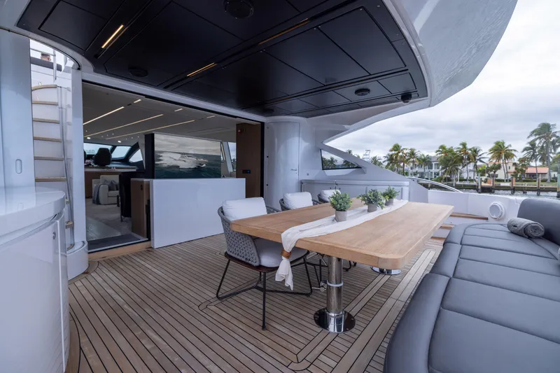 Slide: The Image of Luxurious 2018 Pershing 108 yacht deck with elegant dining area and modern seating. - 37