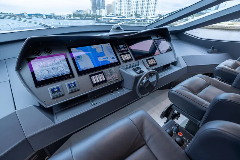 Slide: The Image of Luxurious 2018 Pershing 108 yacht cockpit with advanced navigation systems and leather seating. - 47