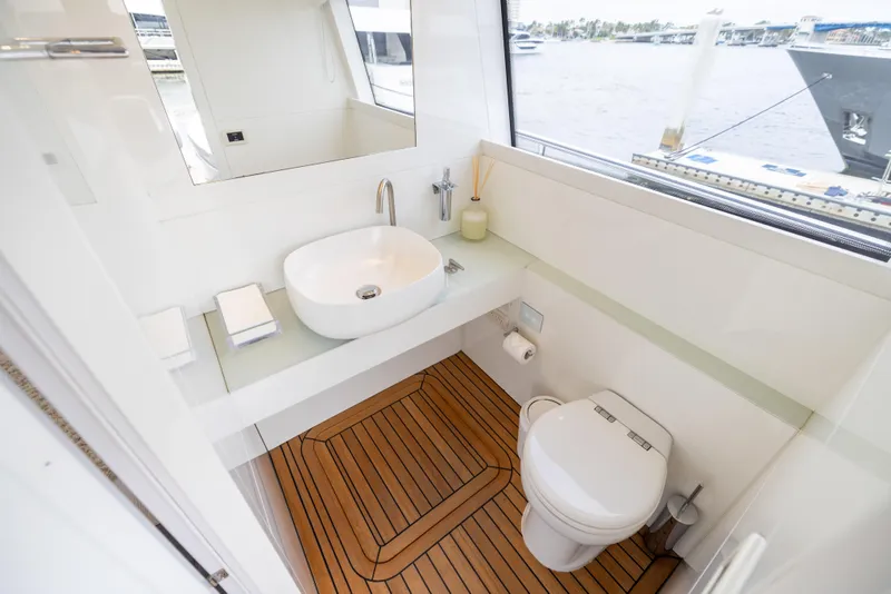 Slide: The Image of Luxurious bathroom on 2018 Pershing 108 yacht with modern fixtures and wooden flooring. - 49