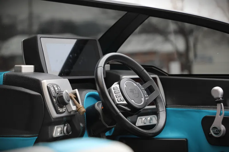 Slide: The Image of 2017 Malibu Wakesetter 22 MXZ dashboard with steering wheel and control panel. - 11