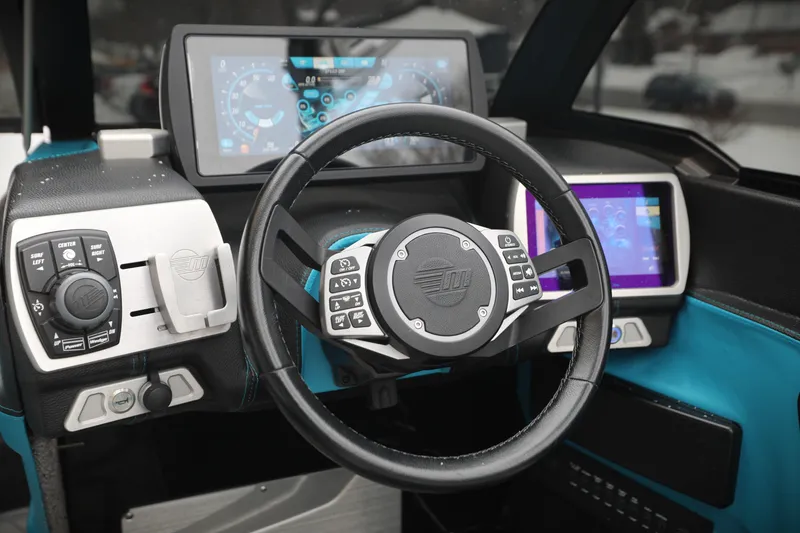 Slide: The Image of 2017 Malibu Wakesetter 22 MXZ dashboard with modern controls and digital displays. - 7