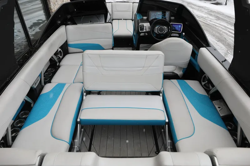 Slide: The Image of 2017 Malibu Wakesetter 22 MXZ interior with white and blue seating, modern dashboard. - 8