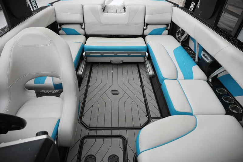 Slide: The Image of 2017 Malibu Wakesetter 22 MXZ interior with white and blue seating, modern design. - 9