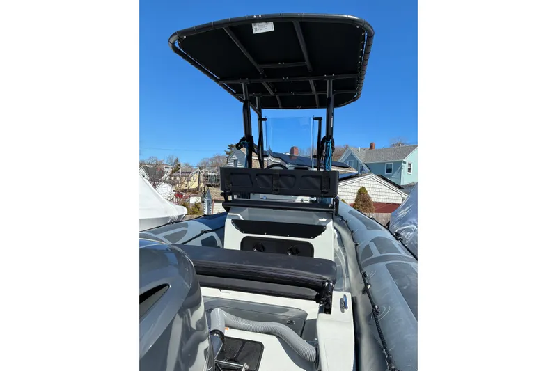 Slide: The Image of 2024 Zodiac Pro 5.5 boat with T-top, docked in residential area. - 4