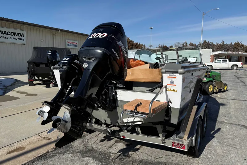 Slide: The Image of 2005 Lund 1850 Tyee boat with dual Mercury outboard motors at a dealership. - 3