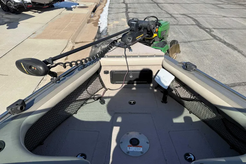 Slide: The Image of 2005 Lund 1850 Tyee boat interior with trolling motor and storage compartments. - 5