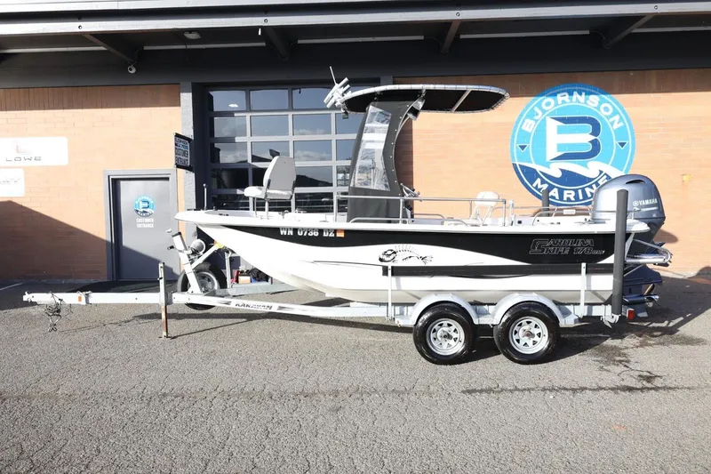 The Image of 2013 Carolina Skiff 178 DLV boat on trailer at Bjornson Marine dealership. - 1