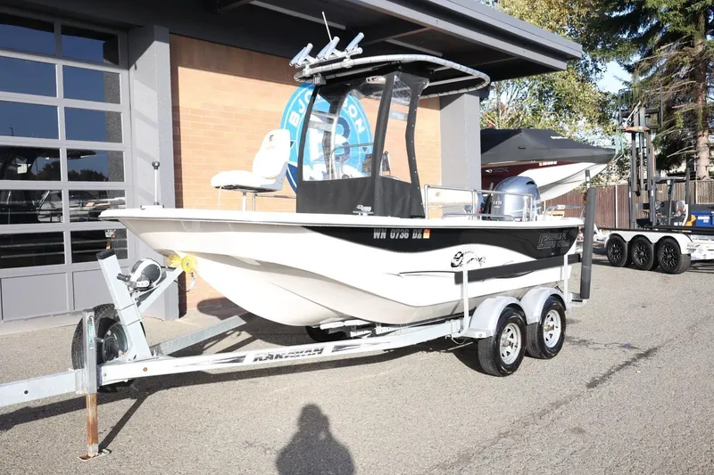 Slide: The Image of 2013 Carolina Skiff 178 DLV boat on trailer outside a building. - 13