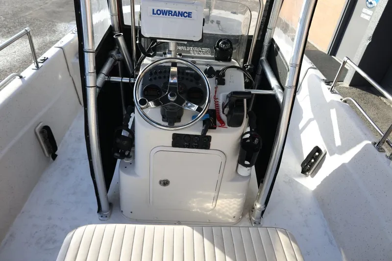 Slide: The Image of 2013 Carolina Skiff 178 DLV boat console with steering wheel and Lowrance equipment. - 19