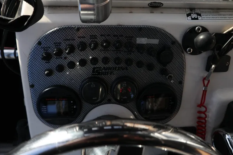 Slide: The Image of Dashboard of a 2013 Carolina Skiff 178 DLV boat with control panel and gauges. - 21