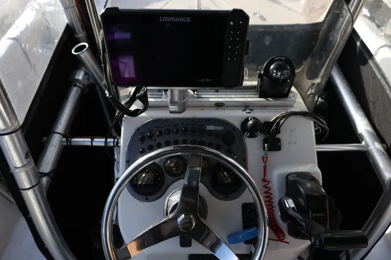 Slide: The Image of 2013 Carolina Skiff 178 DLV boat dashboard with Lowrance GPS and steering wheel. - 22