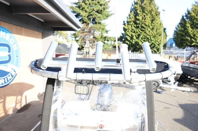 Slide: The Image of 2013 Carolina Skiff 178 DLV boat with rod holders and outdoor setting. - 45