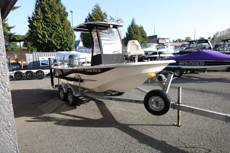 Slide: The Image of 2013 Carolina Skiff 178 DLV boat on trailer in outdoor lot. - 9