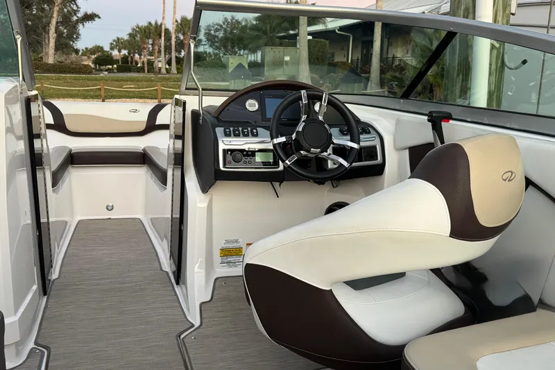 Slide: The Image of 2016 Regal 23 OBX boat interior with steering wheel and seating area. - 12