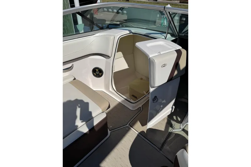 Slide: The Image of 2016 Regal 23 OBX boat interior with seating and speaker, docked at marina. - 16