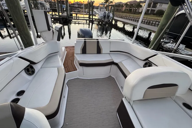 Slide: The Image of 2016 Regal 23 OBX boat interior with white seating and waterfront view. - 21