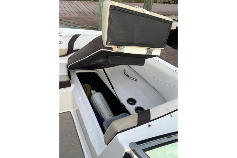 Slide: The Image of 2016 Regal 23 OBX boat interior storage compartment with open seat and accessories. - 24