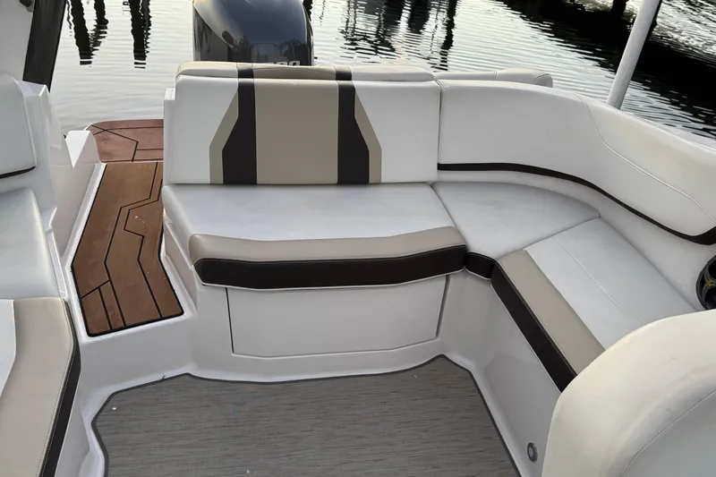 Slide: The Image of 2016 Regal 23 OBX boat interior with cushioned seating and wooden flooring. - 25