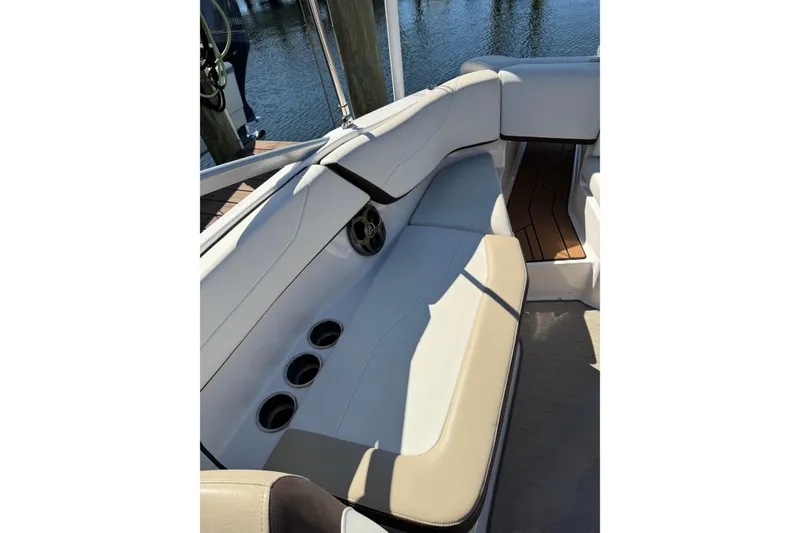 Slide: The Image of 2016 Regal 23 OBX boat interior with steering wheel and seating area. - 9