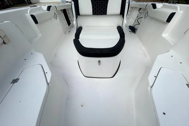 Slide: The Image of 2022 Tidewater 256 CC Adventure boat interior with white seating and storage compartments. - 12