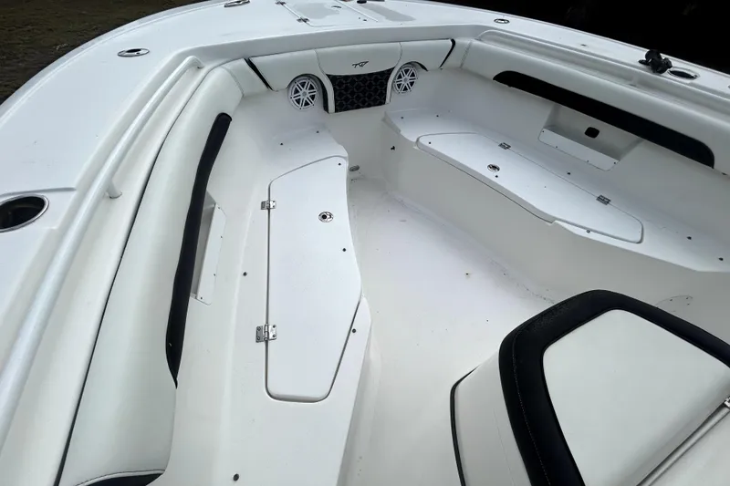 Slide: The Image of 2022 Tidewater 256 CC Adventure boat interior with seating and storage compartments. - 15