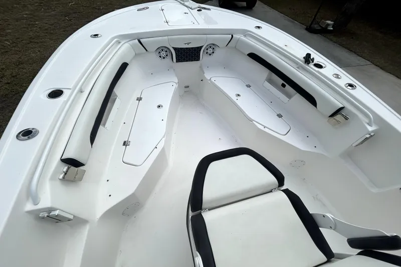 Slide: The Image of 2022 Tidewater 256 CC Adventure boat interior with seating and storage compartments. - 16
