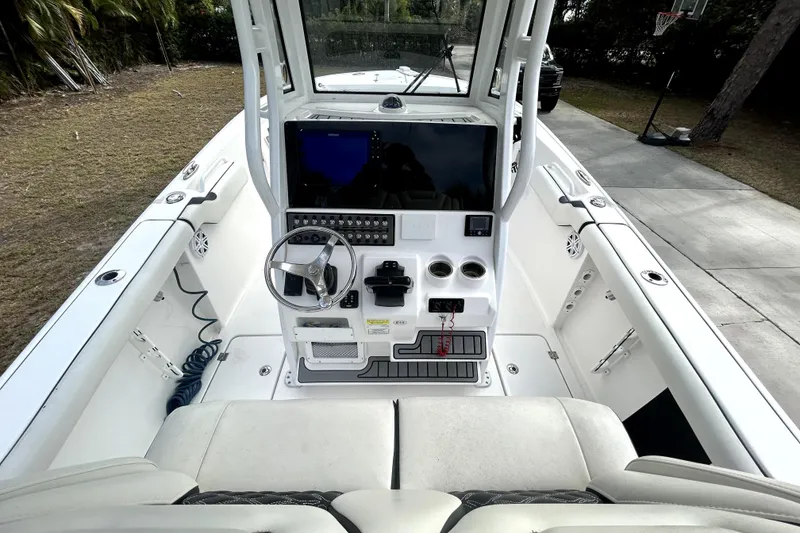 Slide: The Image of 2022 Tidewater 256 CC Adventure boat cockpit with steering wheel and control panel. - 6