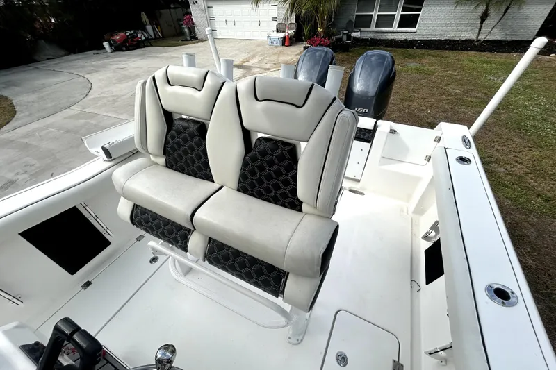 Slide: The Image of 2022 Tidewater 256 CC Adventure boat with dual seats and twin engines. - 9