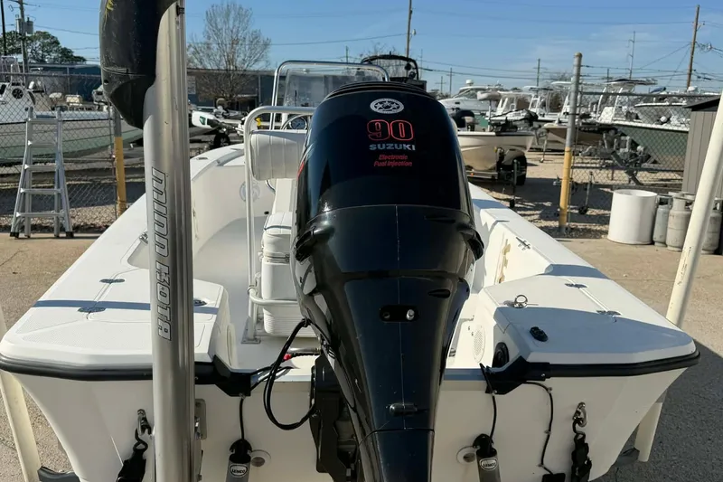 Slide: The Image of 2007 Mako 1801 Inshore boat with Suzuki 90 engine, parked in a marina. - 10