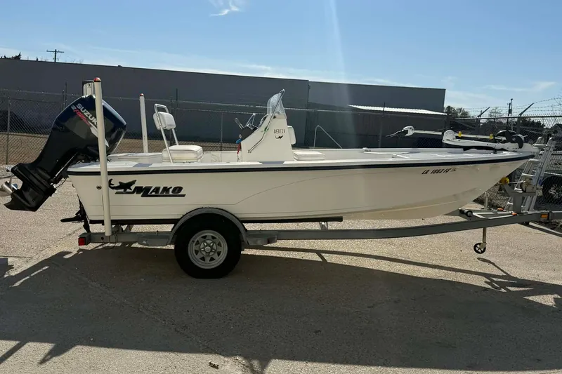 Slide: The Image of 2007 Mako 1801 Inshore boat on trailer with Suzuki outboard motor. - 11