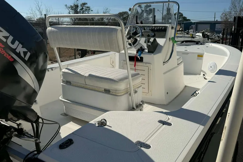 Slide: The Image of 2007 Mako 1801 Inshore boat with Suzuki outboard motor, featuring a spacious deck and seating. - 12
