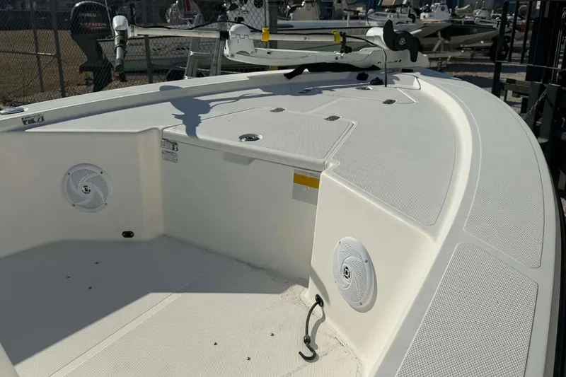 Slide: The Image of 2007 Mako 1801 Inshore boat deck with speakers and storage compartments. - 13