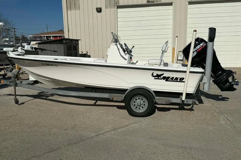 Slide: The Image of 2007 Mako 1801 Inshore boat on trailer with Suzuki outboard motor. - 2
