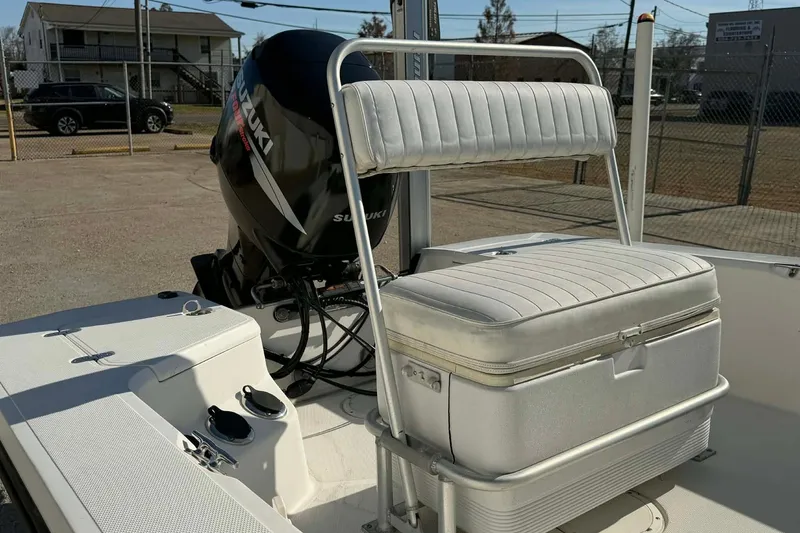 Slide: The Image of 2007 Mako 1801 Inshore boat with Suzuki outboard motor and cushioned seating. - 5
