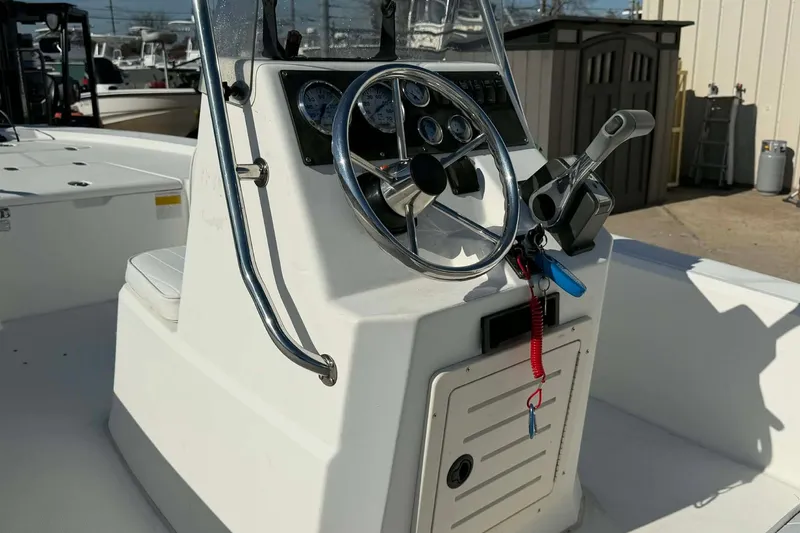 Slide: The Image of 2007 Mako 1801 Inshore boat console with steering wheel and controls. - 7