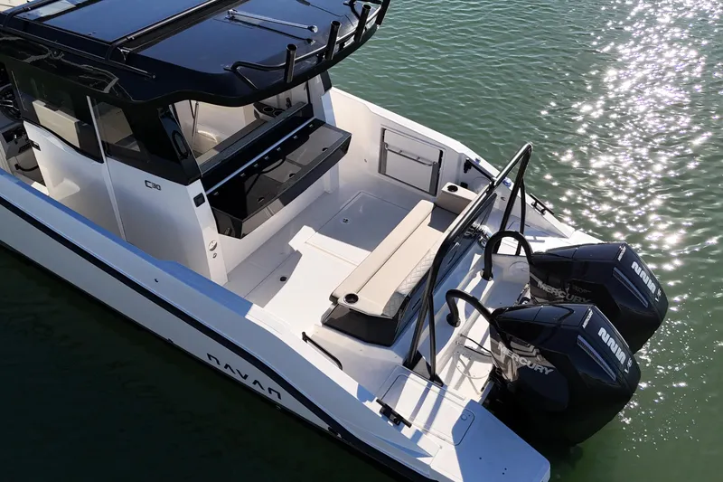 Slide: The Image of 2026 Navan C30 boat with dual Mercury engines on calm water. - 10