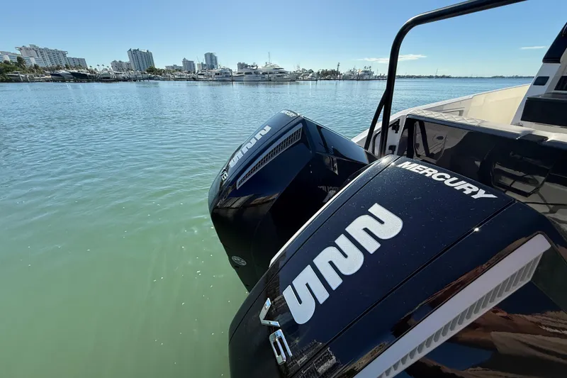 Slide: The Image of Twin Mercury outboard engines on a Navan C30 boat, 2026 model, docked in a marina. - 13