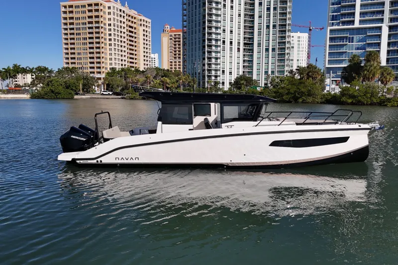 Slide: The Image of 2026 Navan C30 boat on water with city skyline background. - 2