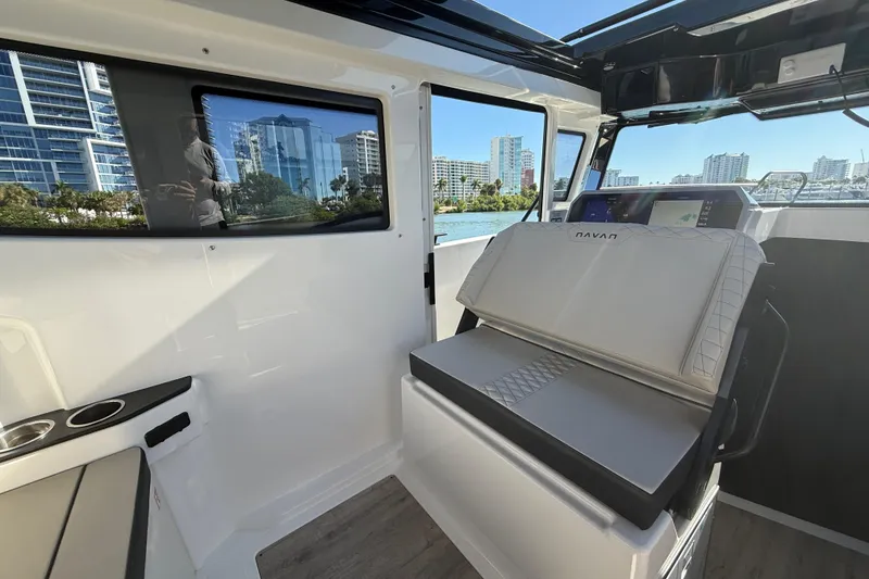 Slide: The Image of Interior of 2026 Navan C30 boat with modern seating and cityscape view. - 21