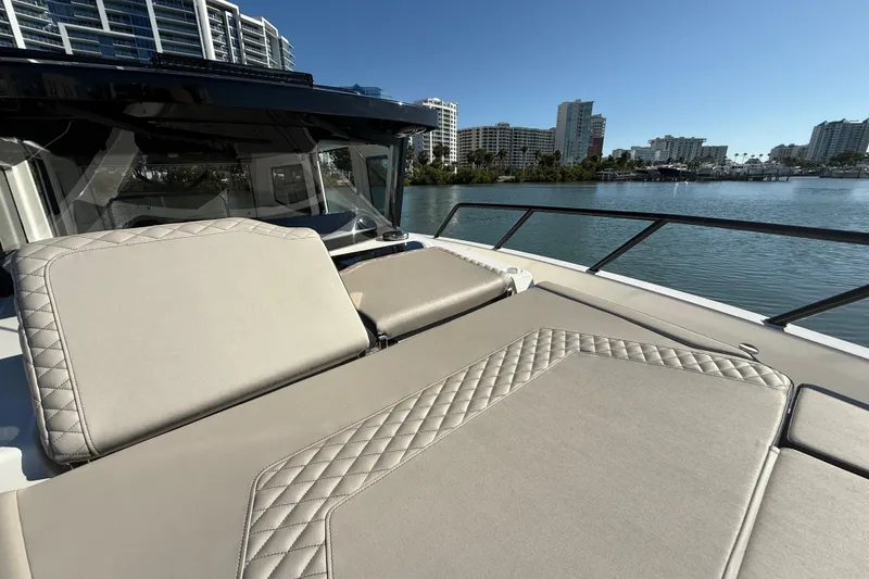 Slide: The Image of Luxurious 2026 Navan C30 yacht with elegant seating, overlooking serene waterfront and cityscape. - 26