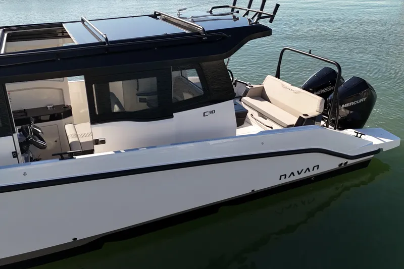 Slide: The Image of Navan C30 2026 boat with sleek design, dual Mercury engines, and modern interior on water. - 7