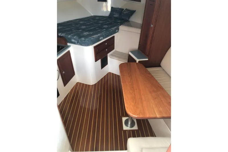 Slide: The Image of 2007 Carolina Classic 35 Express cabin interior with wood flooring and cozy seating area. - 13