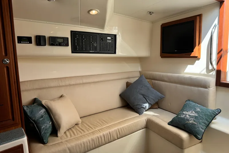 Slide: The Image of Interior of 2007 Carolina Classic 35 Express with beige seating and control panel. - 16