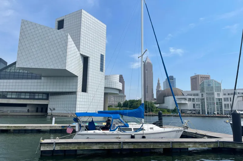 Slide: The Image of Sailboat Catalina 28 (1993) docked near modern architecture and city skyline. - 3