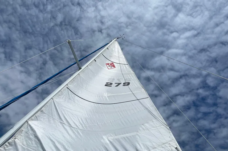 Slide: The Image of Sail of 1993 Catalina 28 yacht against a cloudy sky. - 10