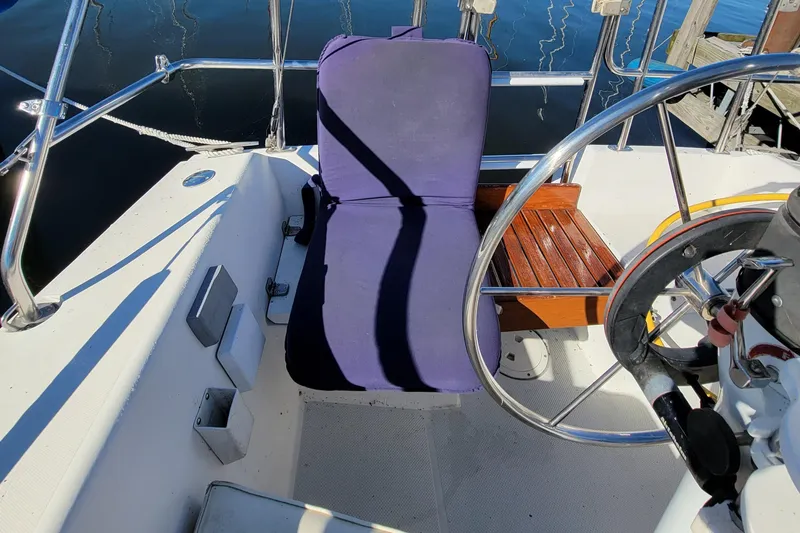 Slide: The Image of Cockpit of 1993 Catalina 28 sailboat with blue seat cushion and steering wheel. - 4