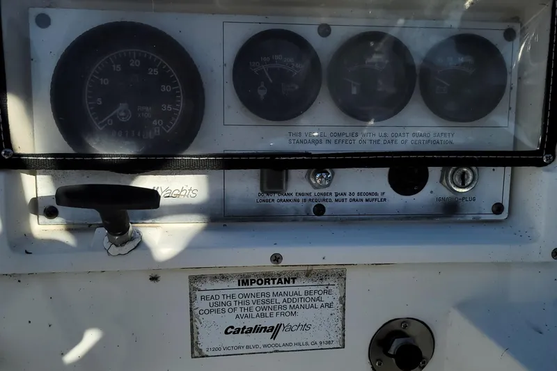 Slide: The Image of Control panel of a 1993 Catalina 28 yacht with gauges and safety instructions. - 6