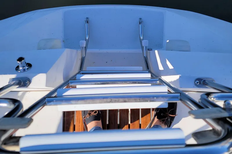 Slide: The Image of View from a 1993 Catalina 28 sailboat's deck, featuring a metal ladder and wooden flooring. - 29