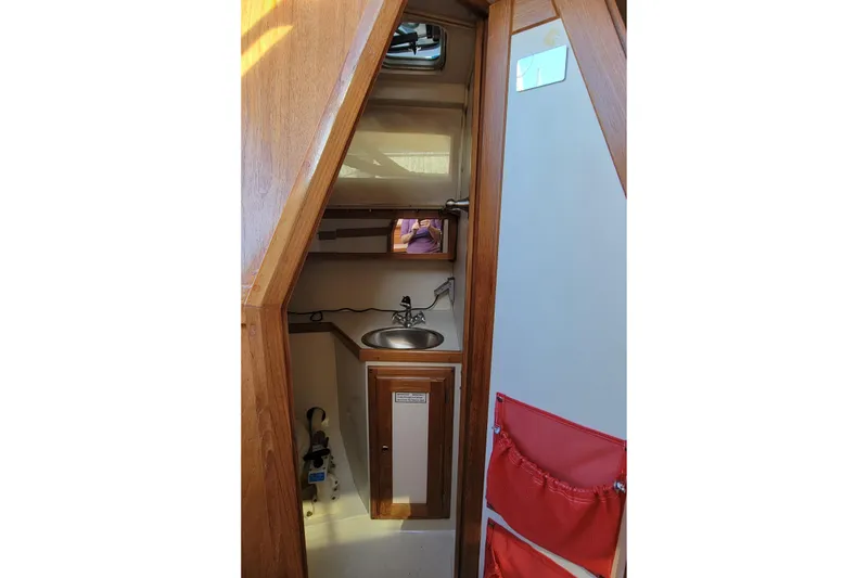 Slide: The Image of Interior of 1993 Catalina 28 sailboat with compact sink and storage. - 25